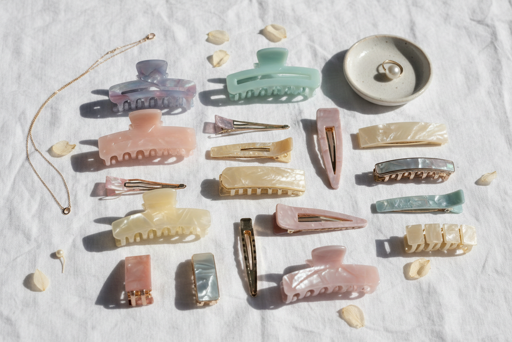 Flat lay of women's hair clips on white linen